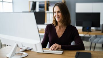 woman working on computer ensuring email compliance for email marketing campaigns