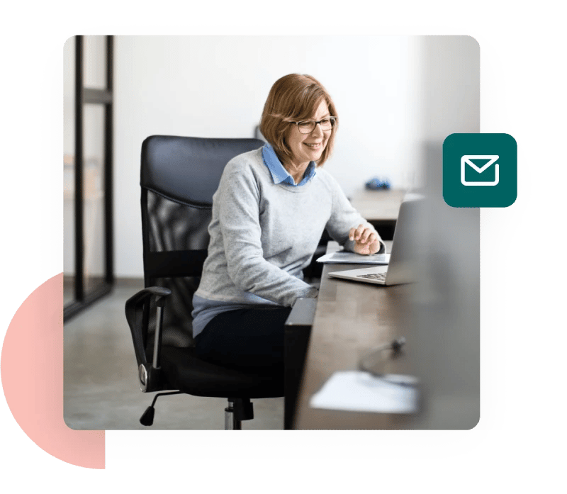 A woman at her desk enjoying better email protection thanks to a DKIM generator tool.