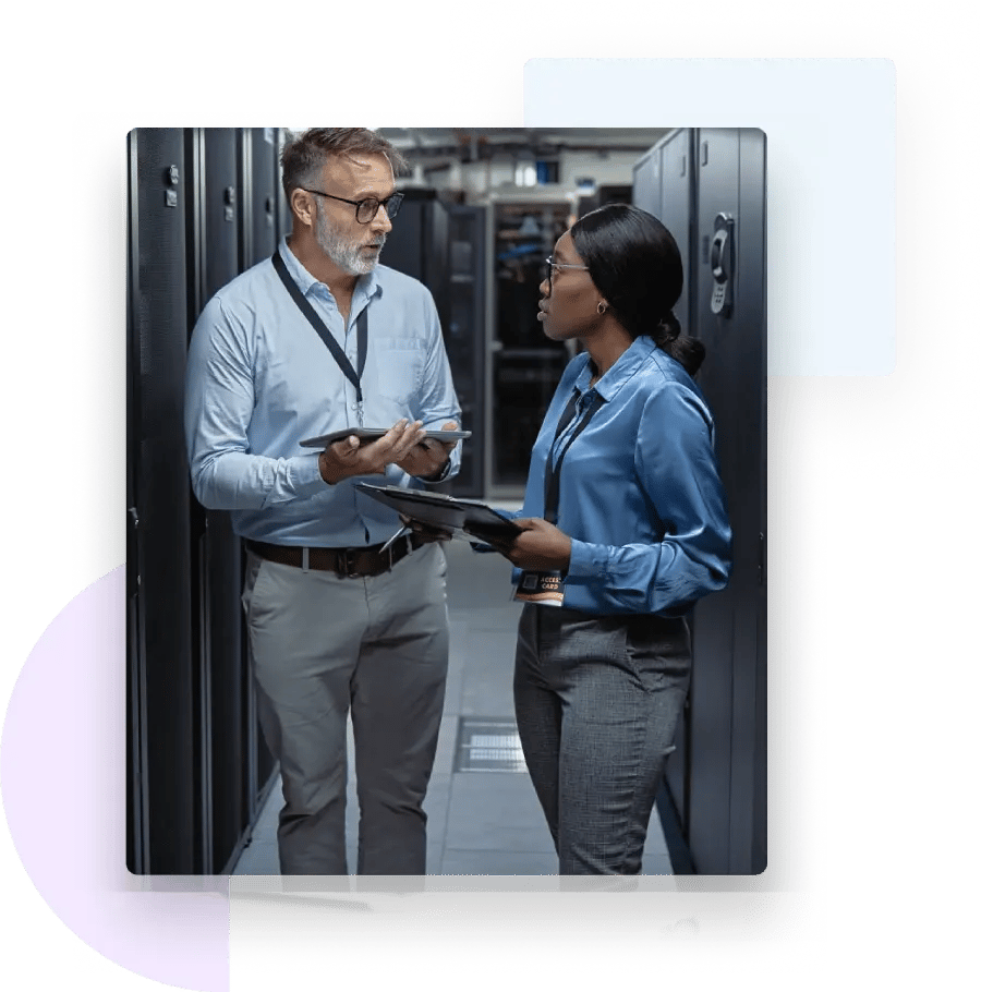 Man and woman discussing ZeroBounce cybersecurity and identity protection in a server room