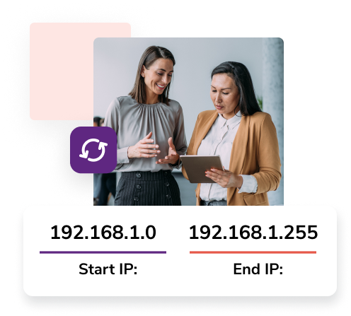 Two women business partners talk and hold a tablet in front of the start IP address ‘192.168.1.0’ and end IP address ‘192.168.1.255.’