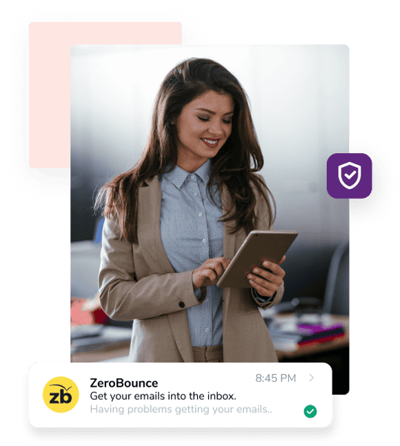 A woman in a blue shirt and brown jacket smiles while holding a tablet next to an email from ZeroBounce with the company logo on the left and the subject line “Get your emails into the inbox.”