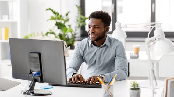 young man working on his computer creating some of the best email personalization examples for marketing