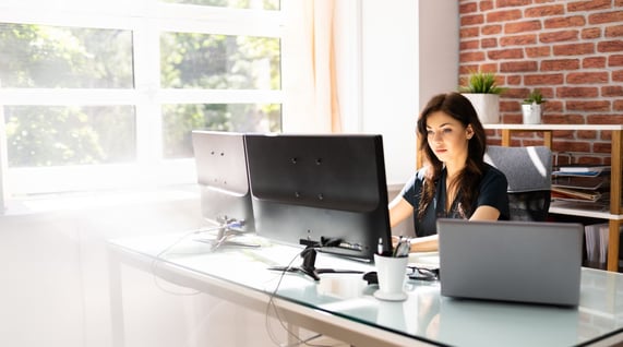 woman working on computer checking email list health for email marketing